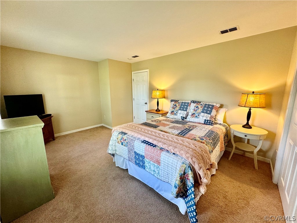 7217 Full Rack Drive Midlothian, VA 23112 - Photo 11 of 23 a spacious bedroom with a bed and wooden floor