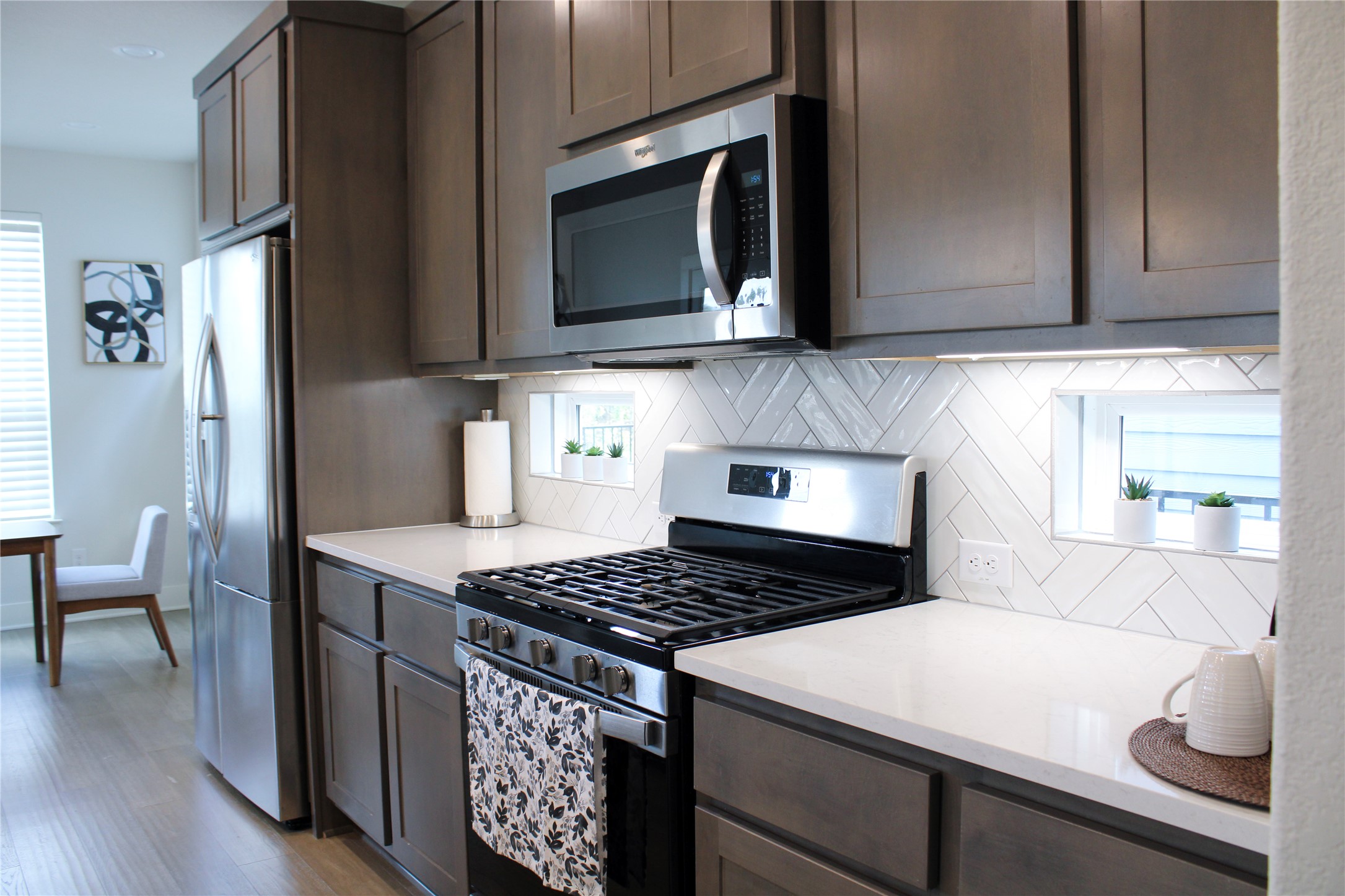 1007 Harwell Loop Kyle, TX 78640 - Photo 20 of 40 a kitchen with stainless steel appliances a stove a microwave and cabinets