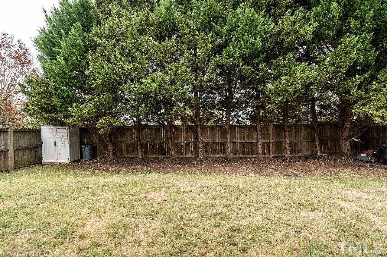 7443 Lagrange Drive Raleigh, NC 27613 - Photo 28 of 28 a backyard of a house with lots of plants and tree