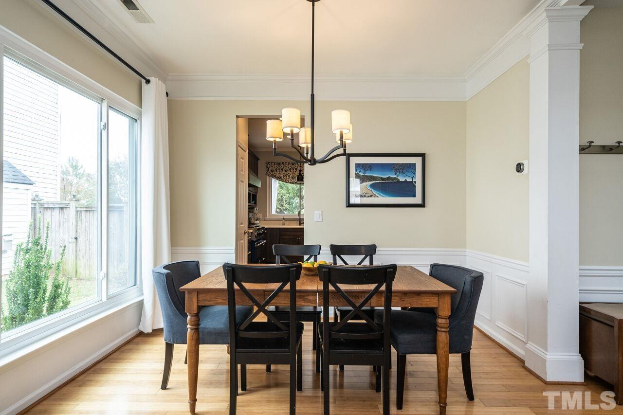 7443 Lagrange Drive Raleigh, NC 27613 - Photo 7 of 28 a view of a dining room with furniture window and wooden floor