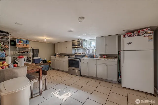 a bathroom with a sink a toilet and shower curtain