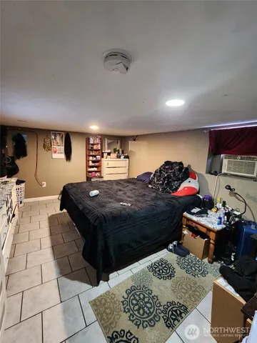 a bedroom with a bed and a couch