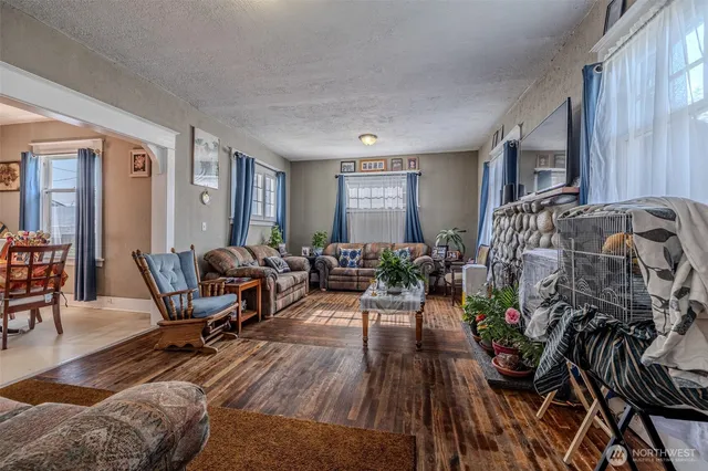 a living room with furniture windows and a wooden floor