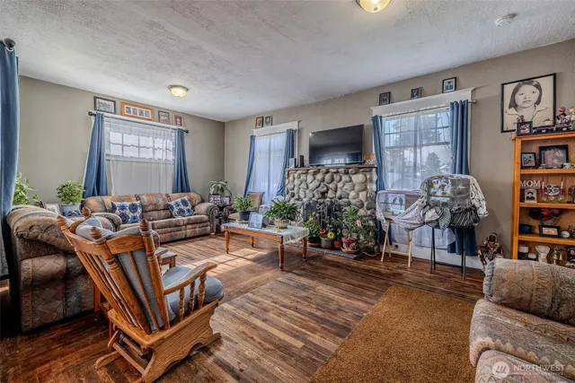 a living room with furniture a bookshelf and a window