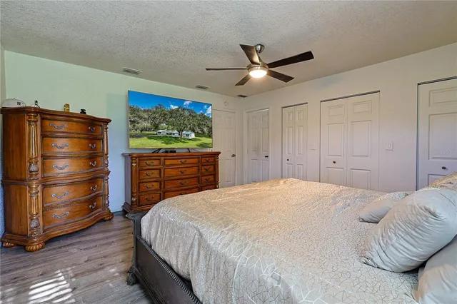 a bedroom with a bed and a television