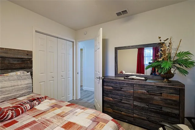 a bedroom with a bed and a potted plant