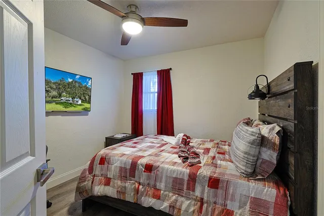 a bedroom with a bed and a chandelier