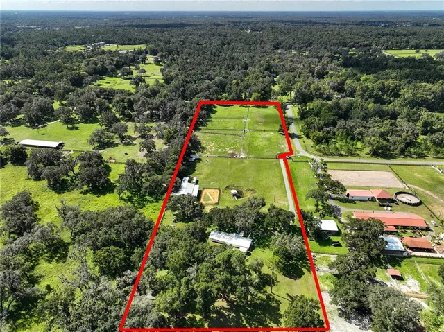 an aerial view of multiple houses with yard