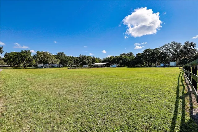 an aerial view of a tennis ground and a large pool
