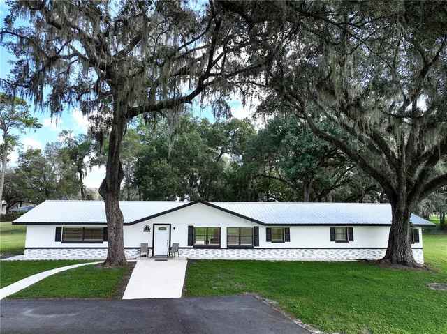 a house with a garden and trees