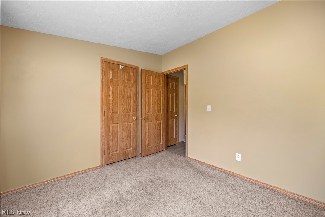 294 Twp 150 Road Sullivan, OH 44880 - Photo 23 of 39 Neutral-toned walls complement the light brown carpet