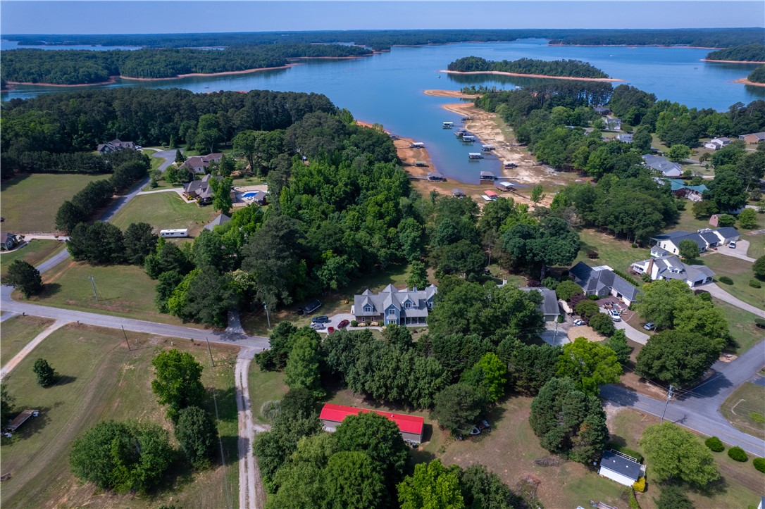 1504 Double Springs Road Townville, SC 29689 - Photo 39 of 41 This aerial view showcases a vibrant community nestled alongside a serene lake.