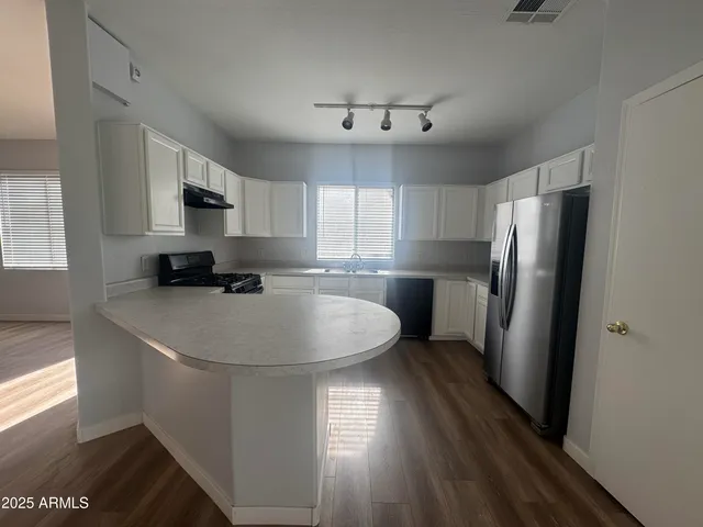 a kitchen with stainless steel appliances a refrigerator sink and microwave