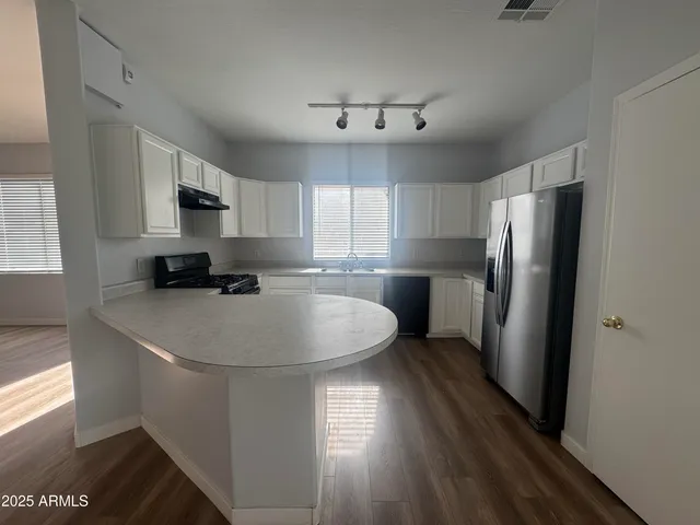 a kitchen with stainless steel appliances a refrigerator sink and microwave