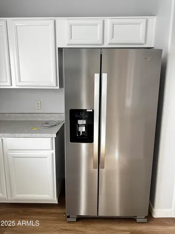 a metallic refrigerator freezer sitting in a kitchen