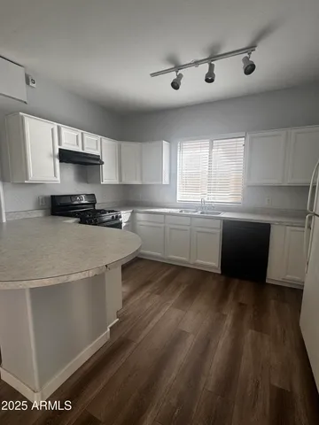 a kitchen with stainless steel appliances granite countertop a sink and a stove