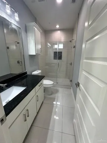 a bathroom with a granite countertop sink mirror and bathtub