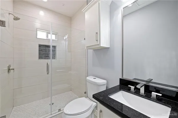 a bathroom with a sink toilet and shower
