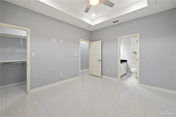 a view of an empty room and a bathroom