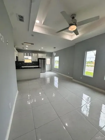 a large hall with stainless steel appliances lots of counter space
