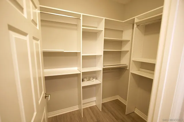 a view of walk in closet with empty racks