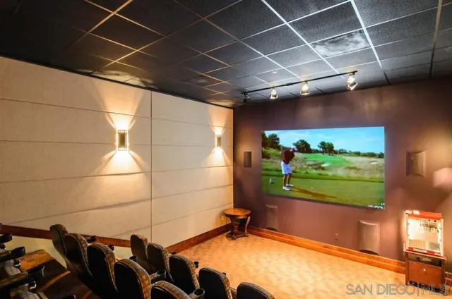 an open kitchen with granite countertop a dining table chairs and white cabinets