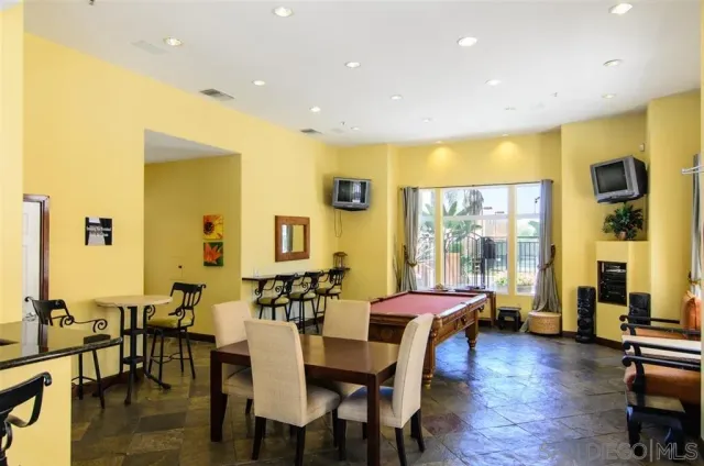 a living room with furniture fireplace and a large window