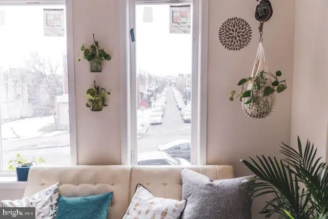 a living room with furniture and a potted plant
