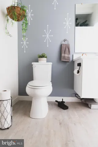 a bathroom with a sink toilet and mirror