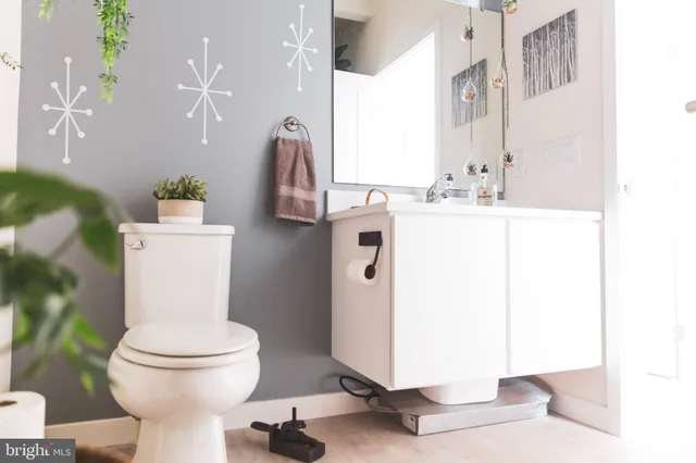 a bathroom with a sink a toilet and a mirror