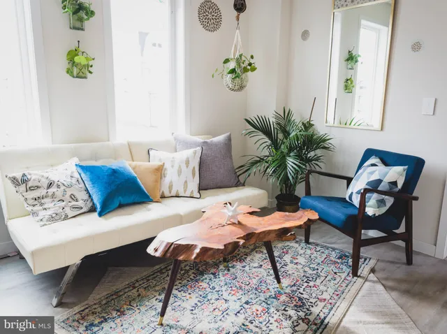 a living room with furniture and wooden floor