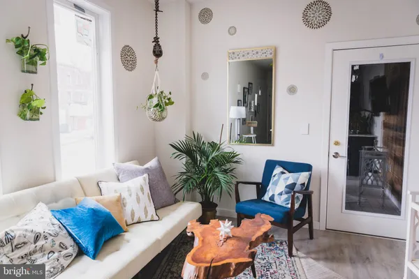 a living room with furniture rug and wooden floor