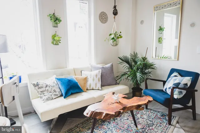 a living room with furniture and wooden floor