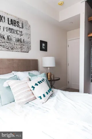 a bedroom with a bed and a night stand