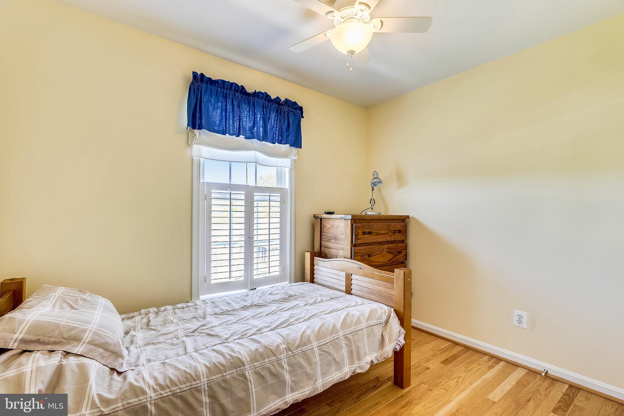 4800 White Marsh Road Baltimore, MD 21237 - Photo 23 of 39 Bedroom with Hardwoods-wooden shutter/ceiling fan