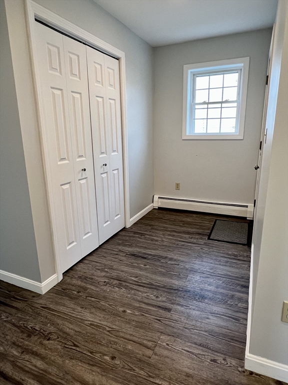 51 Walnut Street, Unit 2 Tiverton, RI 02878 - Photo 11 of 13 a view of an empty room with wooden floor and a window