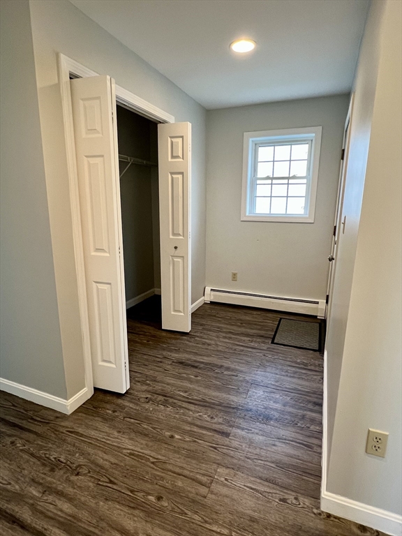 51 Walnut Street, Unit 2 Tiverton, RI 02878 - Photo 12 of 13 an empty room with wooden floor and windows