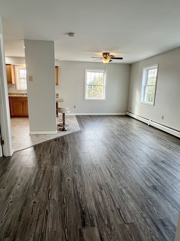 51 Walnut Street, Unit 2 Tiverton, RI 02878 - Photo 2 of 13 an empty room with wooden floor and windows