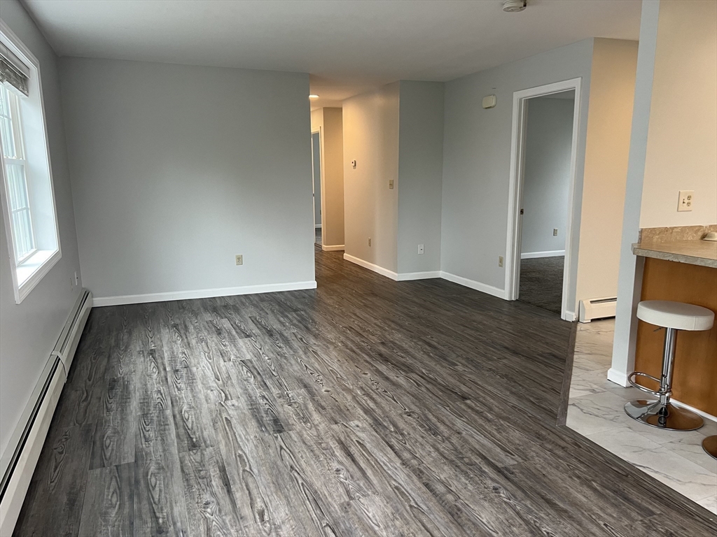 51 Walnut Street, Unit 2 Tiverton, RI 02878 - Photo 3 of 13 wooden floor in an empty room with a window