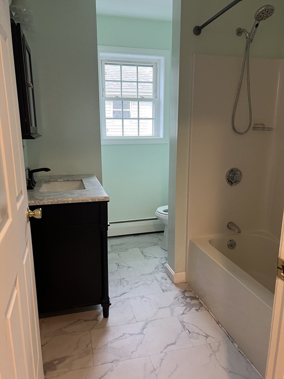 51 Walnut Street, Unit 2 Tiverton, RI 02878 - Photo 8 of 13 a bathroom with a sink a toilet and bathtub