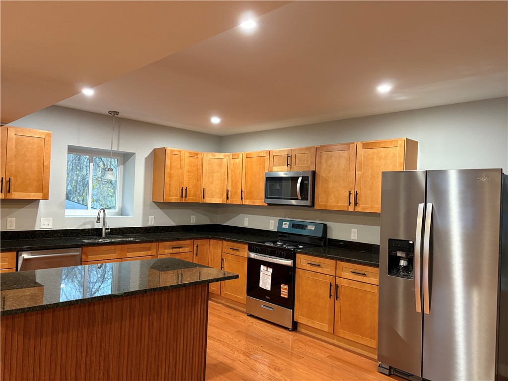 182 Avenue C, Unit S6 Woonsocket, RI 02895 - Photo 4 of 13 Beautiful kitchen featuring granite countertops and island.