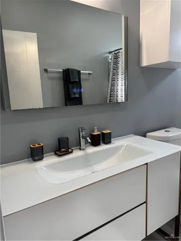 a bathroom with a sink toilet and shower
