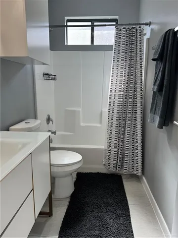 a bedroom with a bed and painting on the wall