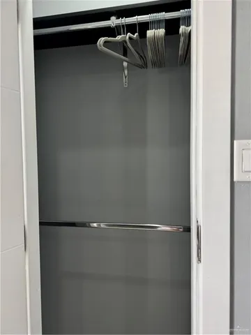 a bedroom with a bed and painting on the wall