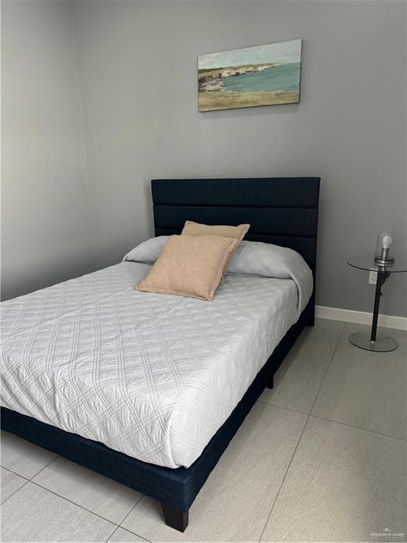 2022 Summerland Lane, Unit 4 Edinburg, TX 78541 - Photo 25 of 31 a bedroom with a bed and painting on the wall