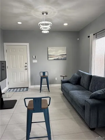 a living room with furniture and a chandelier