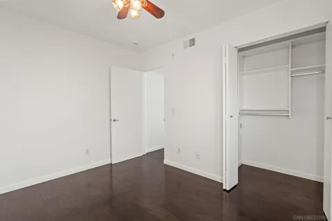a bedroom with a bed and a potted plant
