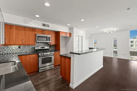 a kitchen with counter top space a sink and appliances