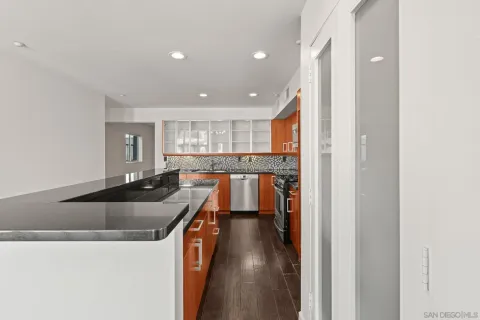 a kitchen with stainless steel appliances granite countertop a refrigerator and a sink