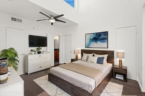 an empty room with closet and a ceiling fan